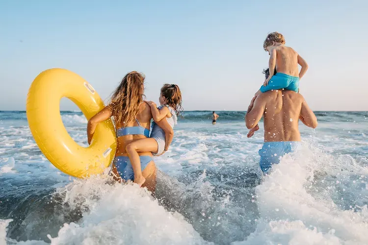 Family playing in the Gulf surf